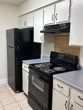 a stove top oven sitting inside of a kitchen