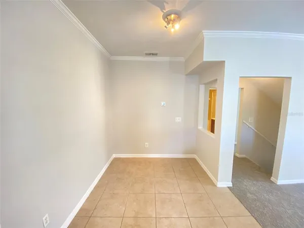 an empty room with windows and entrance