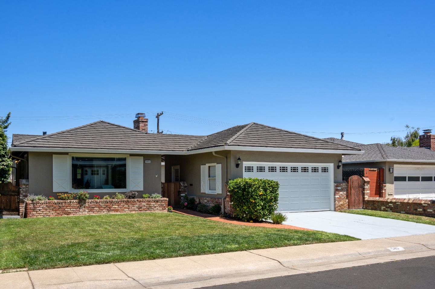 545 Alhambra Road San Mateo, CA 94402 - Photo 1 of 59 a front view of a house with a yard