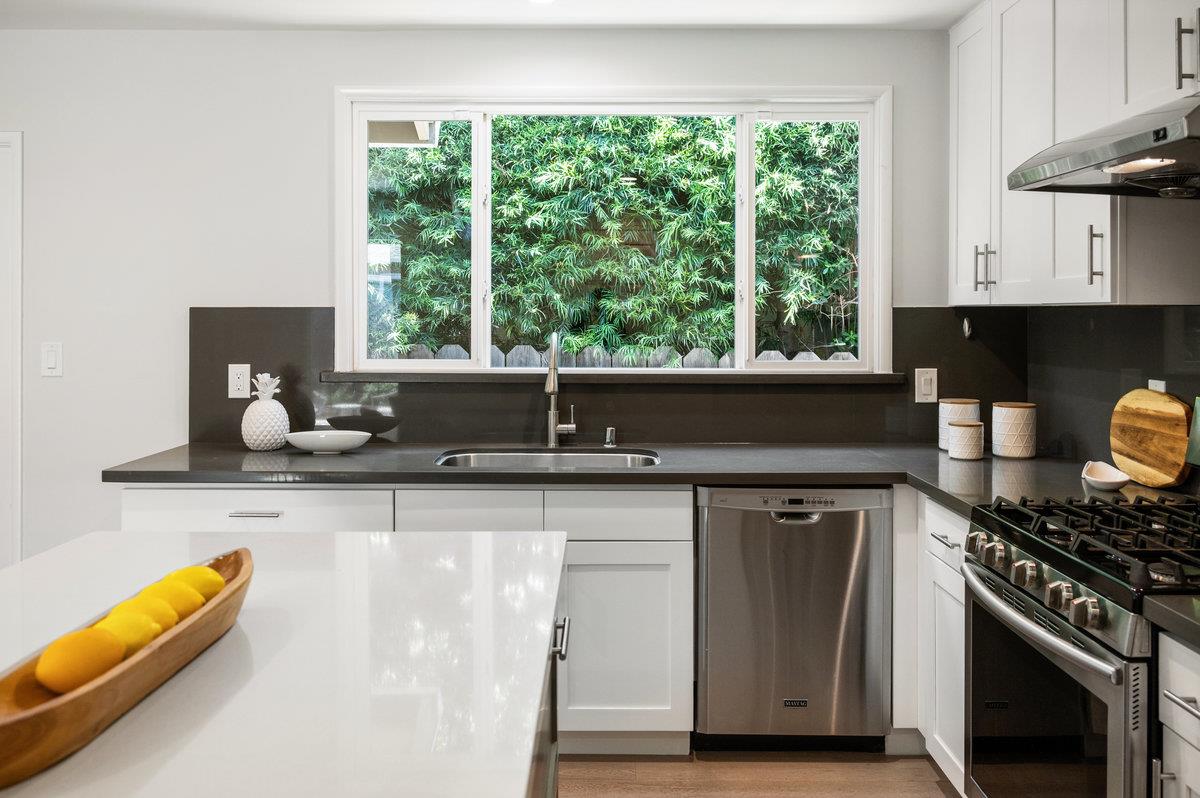 545 Alhambra Road San Mateo, CA 94402 - Photo 11 of 59 a kitchen with a sink a stove and a wooden floor