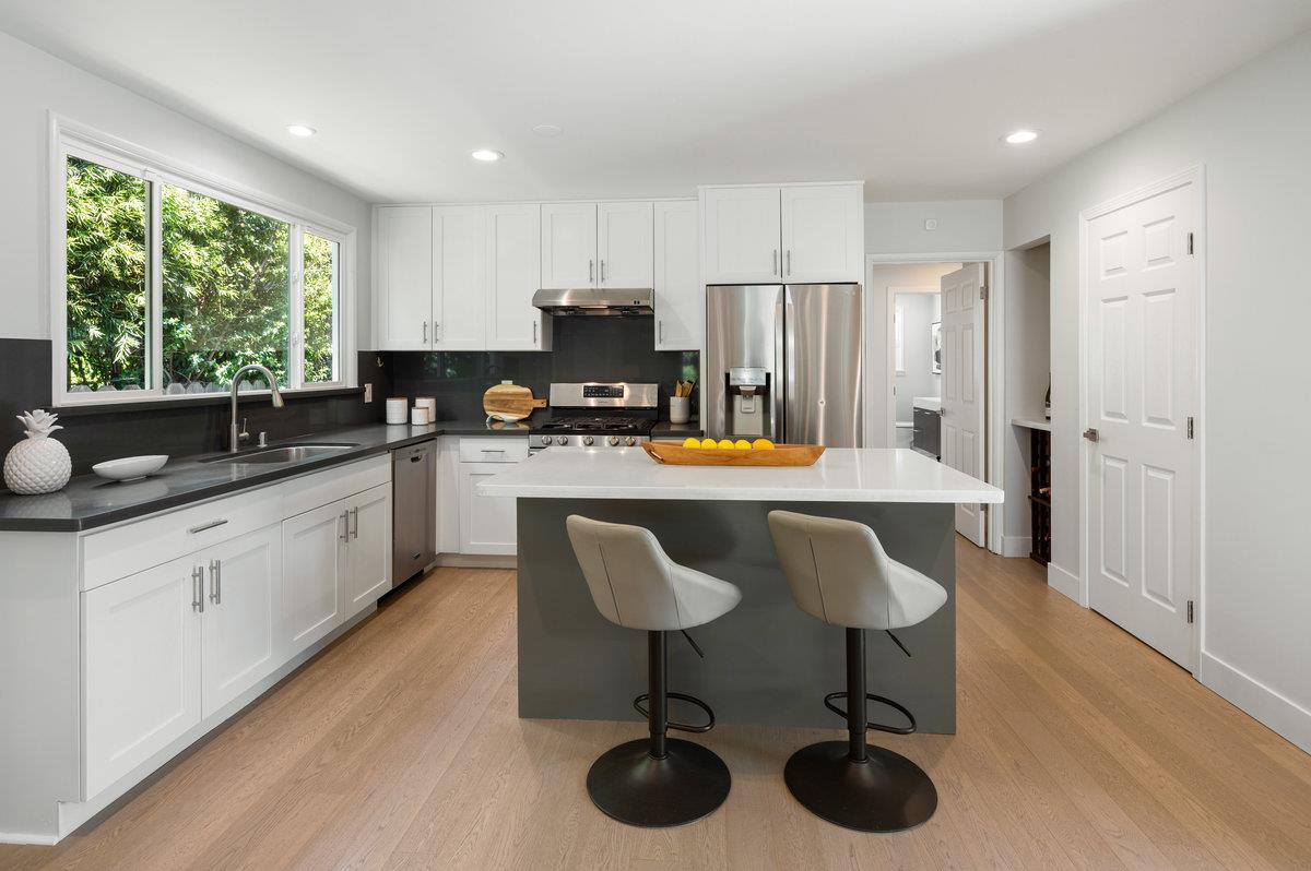 545 Alhambra Road San Mateo, CA 94402 - Photo 12 of 59 a kitchen with stainless steel appliances granite countertop a stove a sink a refrigerator and cabinets
