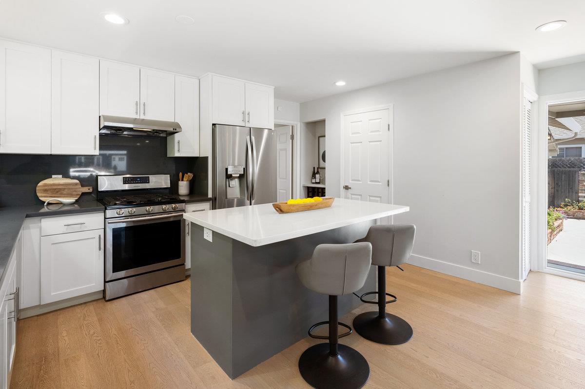 545 Alhambra Road San Mateo, CA 94402 - Photo 15 of 59 a kitchen with a sink cabinets and appliances