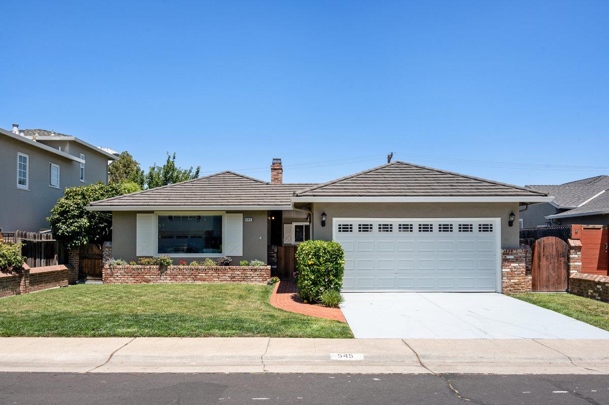 545 Alhambra Road San Mateo, CA 94402 - Photo 2 of 59 a front view of a house with a yard and a garage