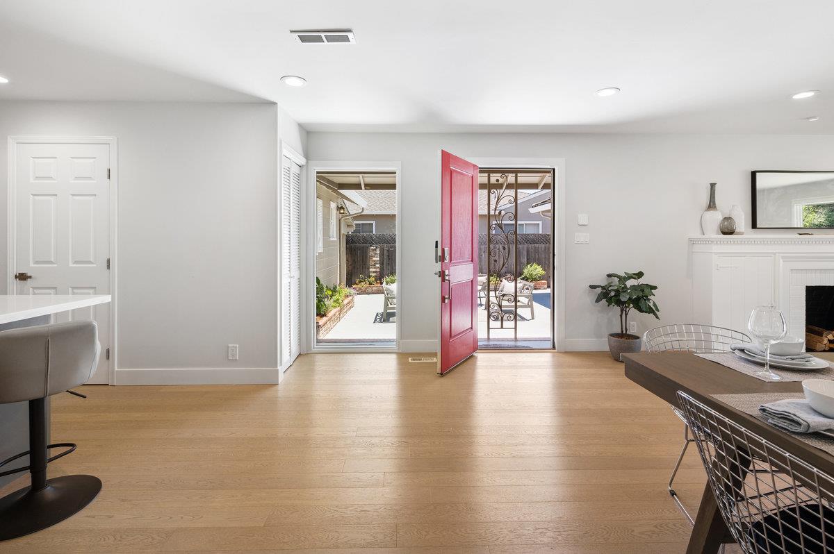 545 Alhambra Road San Mateo, CA 94402 - Photo 24 of 59 a view of a hallway with a dining table and chairs