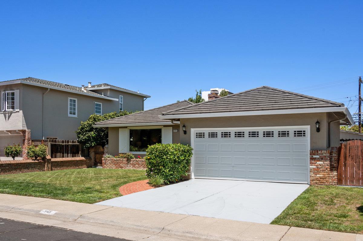 545 Alhambra Road San Mateo, CA 94402 - Photo 3 of 59 a front view of a house with a yard and garage