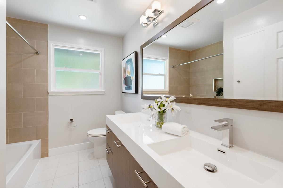 545 Alhambra Road San Mateo, CA 94402 - Photo 37 of 59 a bathroom with a sink a toilet and mirror