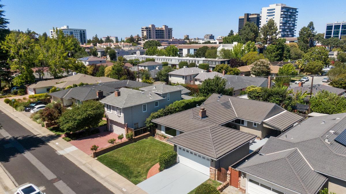 545 Alhambra Road San Mateo, CA 94402 - Photo 50 of 59 an aerial view of a residential apartment building with a yard and outdoor seating