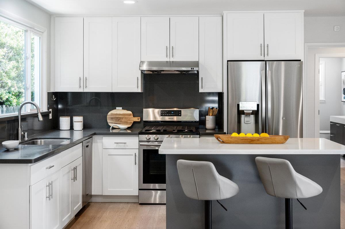 545 Alhambra Road San Mateo, CA 94402 - Photo 10 of 59 a kitchen with stainless steel appliances granite countertop a sink stove and refrigerator