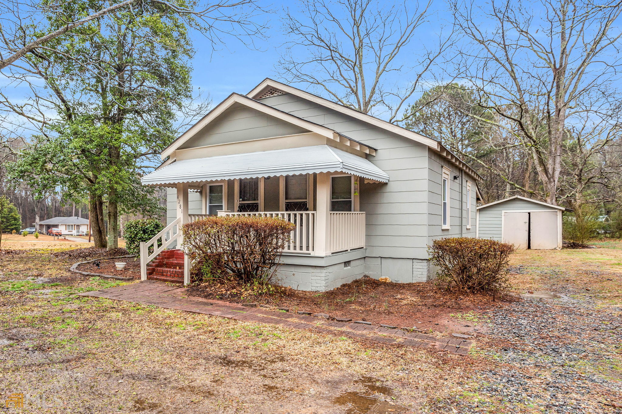 4281 Austell Powder Springs Road Southwest Powder Springs, GA 30127 - Photo 1 of 1 a front view of house with yard and trees in the background