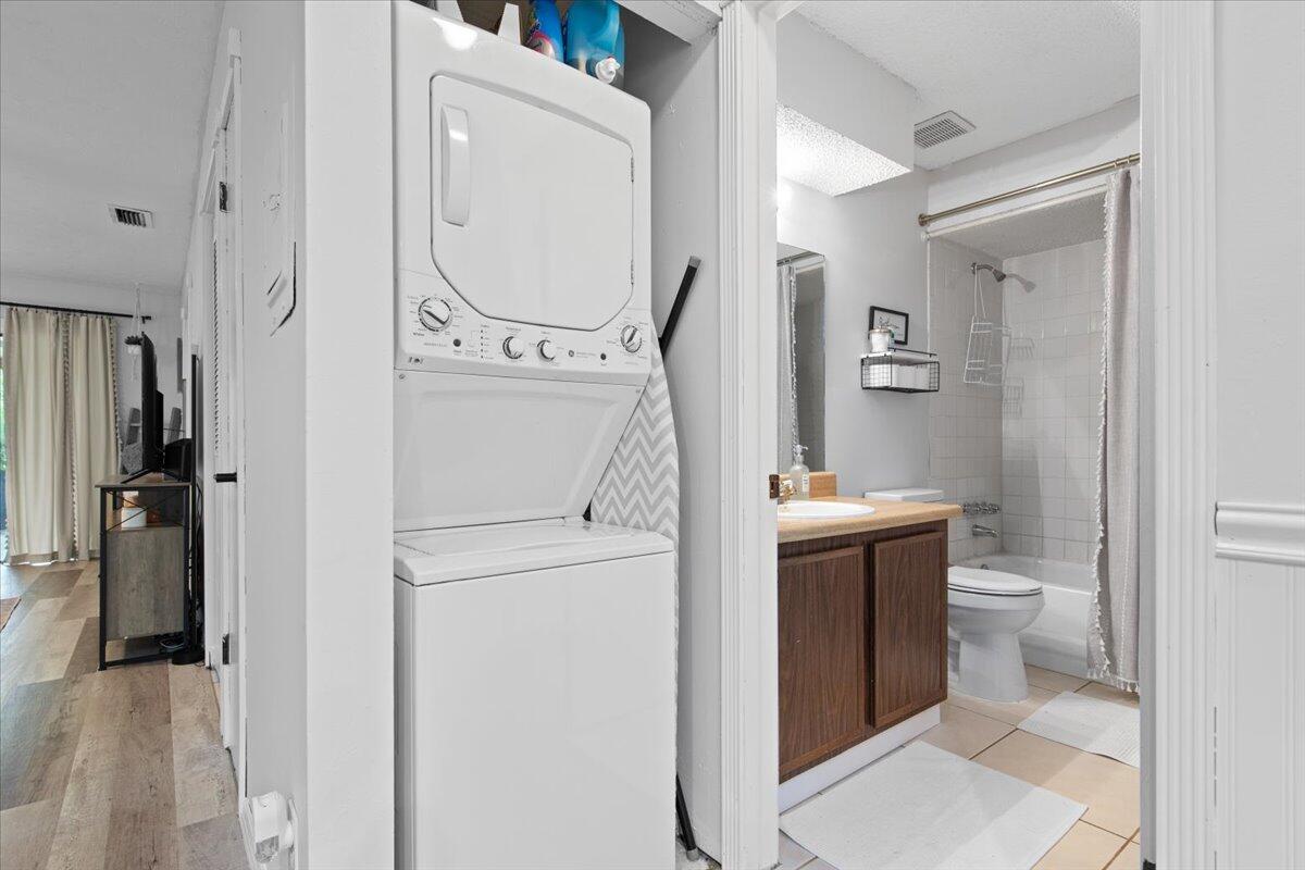 6006 Indrio Road, Unit 7 Fort Pierce, FL 34951 - Photo 15 of 31 a bathroom with a toilet sink and mirror