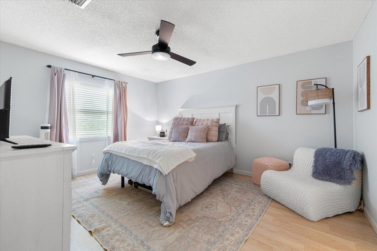 6006 Indrio Road, Unit 7 Fort Pierce, FL 34951 - Photo 20 of 31 a bedroom with a bed couches and window