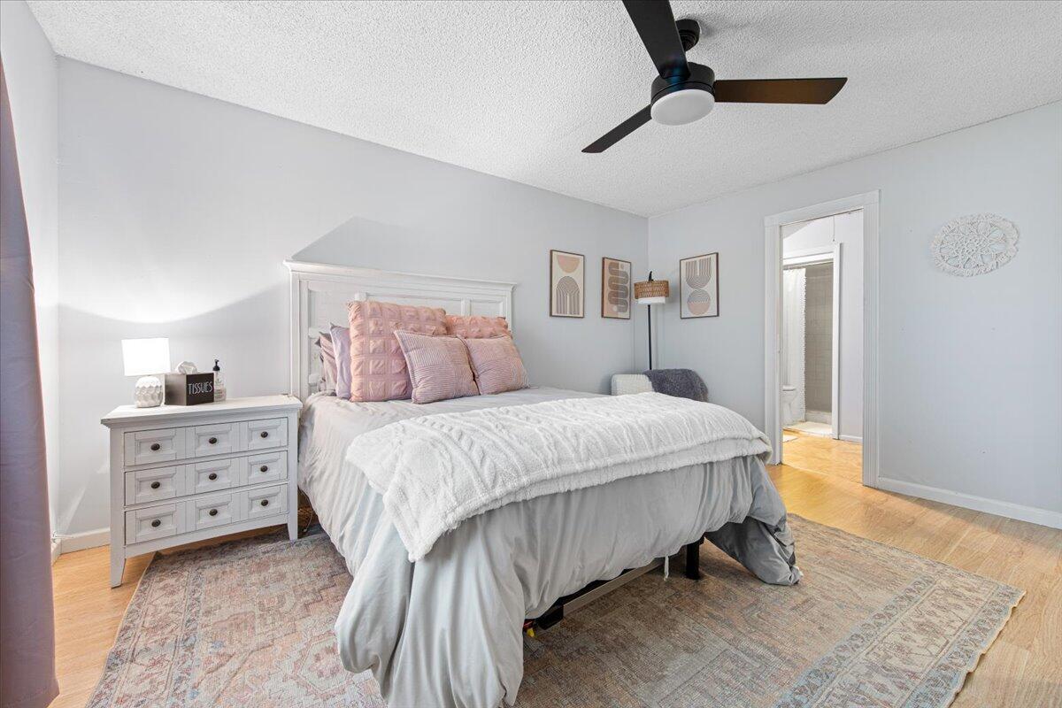 6006 Indrio Road, Unit 7 Fort Pierce, FL 34951 - Photo 21 of 31 a bedroom with a bed and a night stand