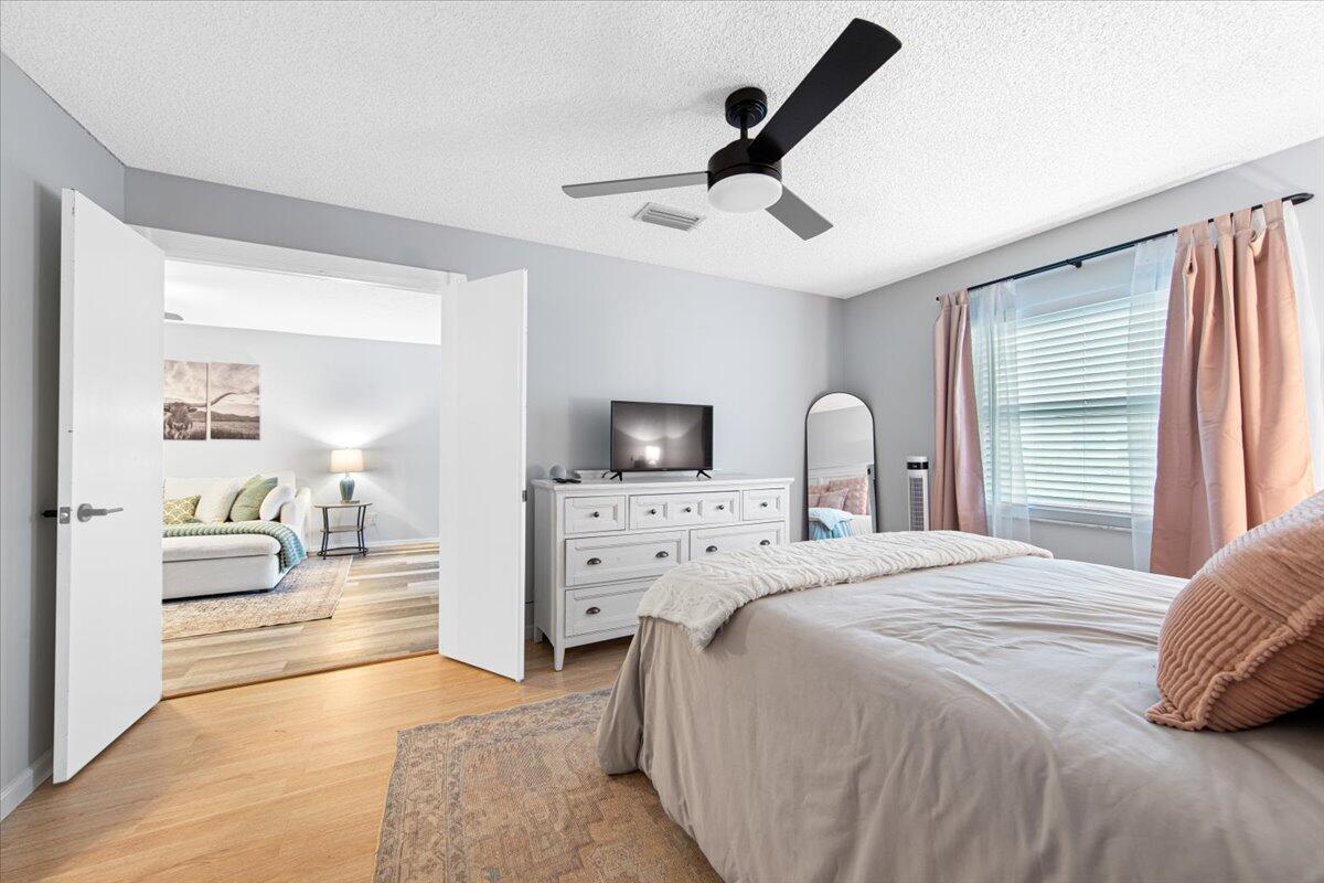 6006 Indrio Road, Unit 7 Fort Pierce, FL 34951 - Photo 22 of 31 a bedroom with a bed and a large window