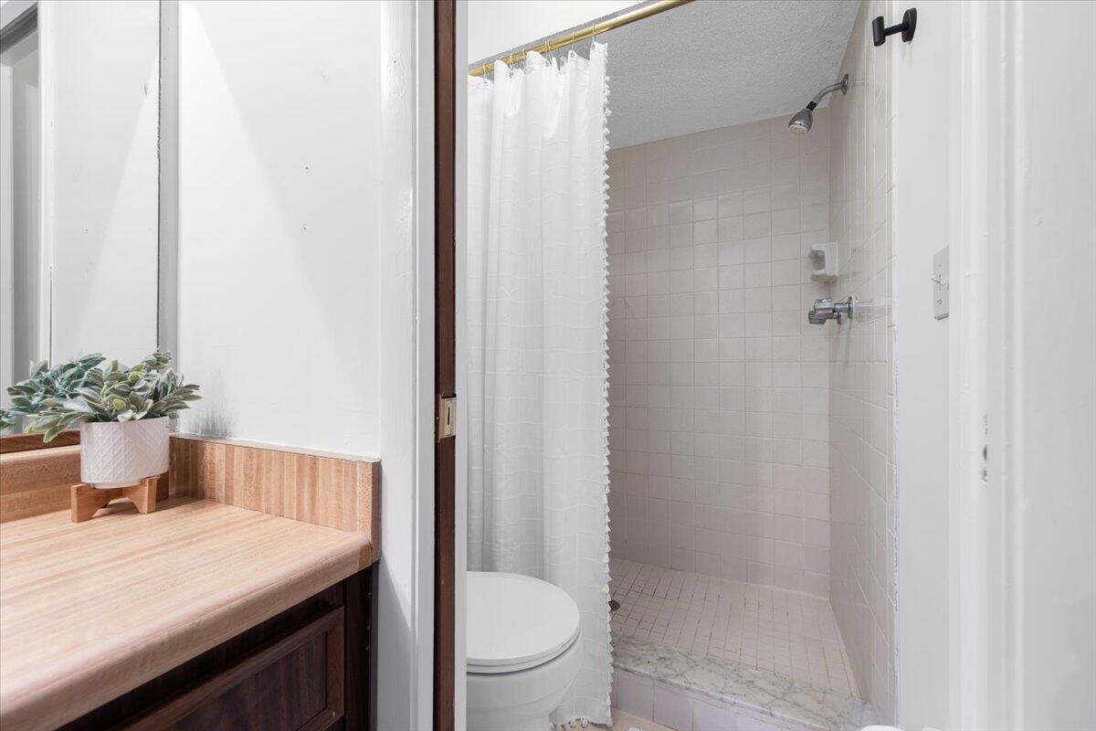 6006 Indrio Road, Unit 7 Fort Pierce, FL 34951 - Photo 24 of 31 a bathroom with a sink a toilet and shower