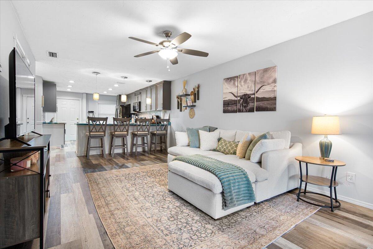 6006 Indrio Road, Unit 7 Fort Pierce, FL 34951 - Photo 5 of 31 a spacious bedroom with a bed a chandelier and a mirror