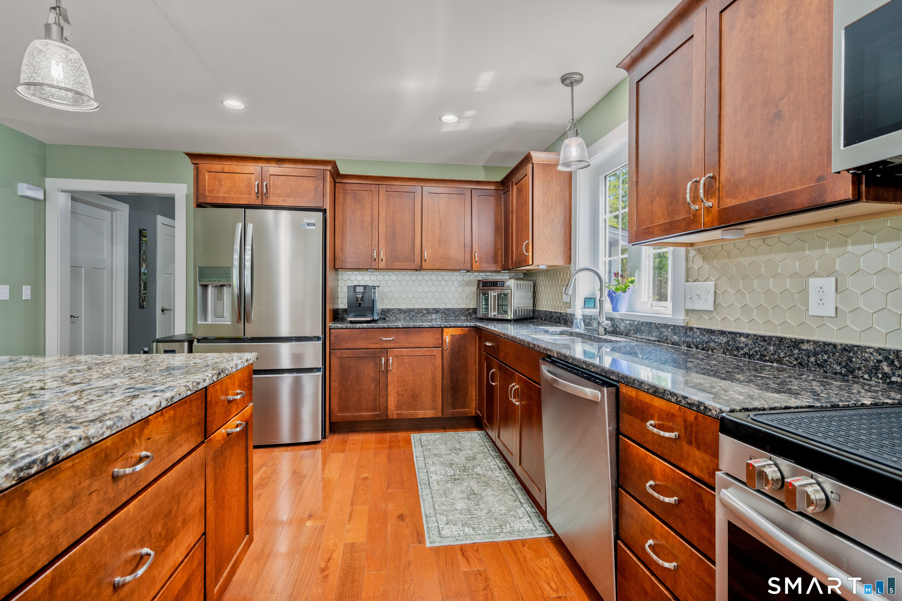 5 Limric Lane Suffield, CT 06078 - Photo 8 of 36 a kitchen with stainless steel appliances granite countertop a sink and wooden cabinets