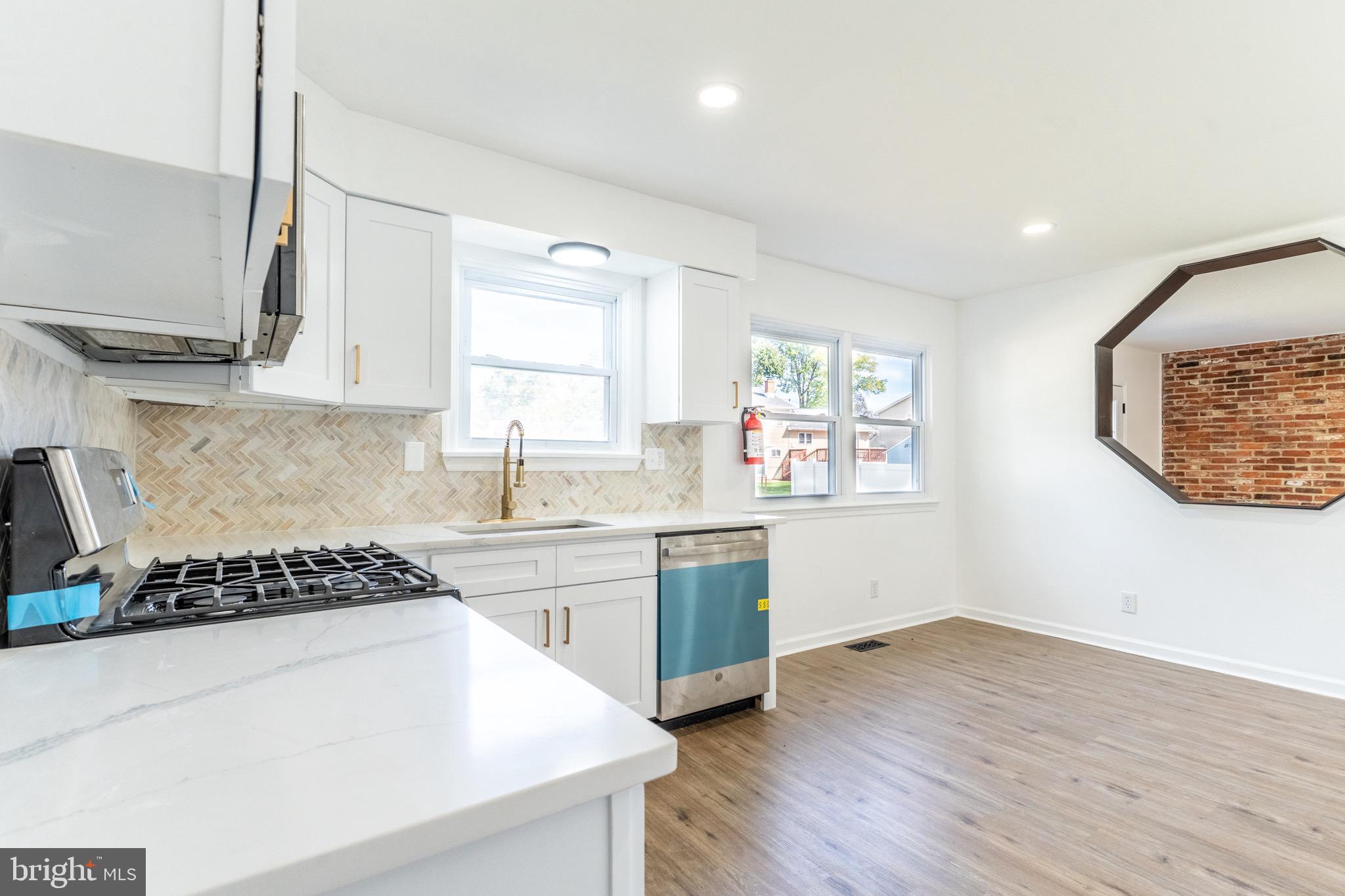 5 Ramsgate Road Cherry Hill, NJ 08003 - Photo 11 of 35 a kitchen with wooden floor and white appliances