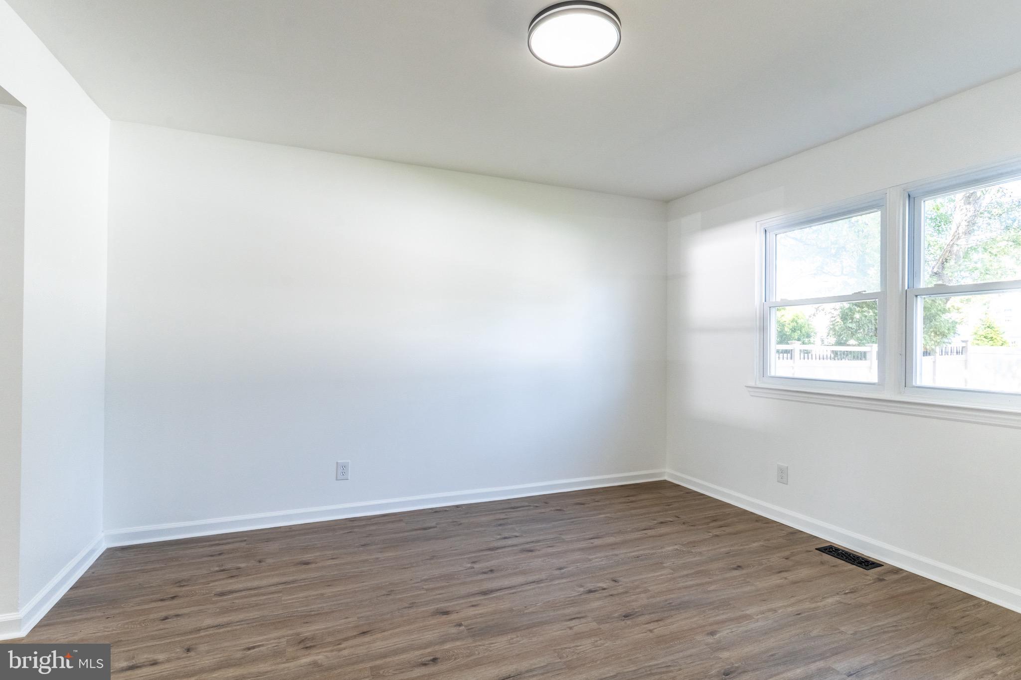 5 Ramsgate Road Cherry Hill, NJ 08003 - Photo 7 of 35 an empty room with wooden floor and windows