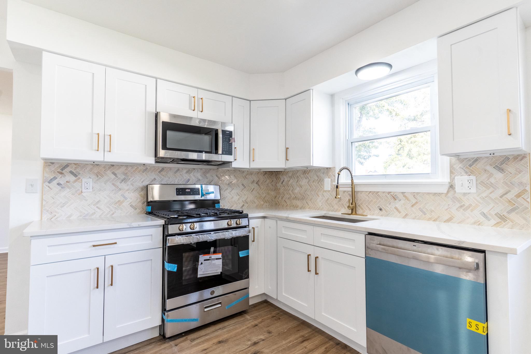 5 Ramsgate Road Cherry Hill, NJ 08003 - Photo 10 of 35 a kitchen with white cabinets appliances and a window