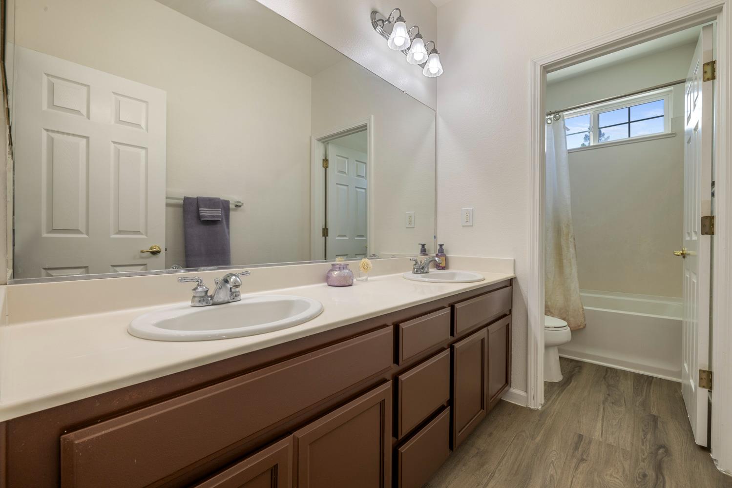 3105 Ripple Court Modesto, CA 95355 - Photo 36 of 46 a bathroom with a double vanity sink toilet mirror and bathtub