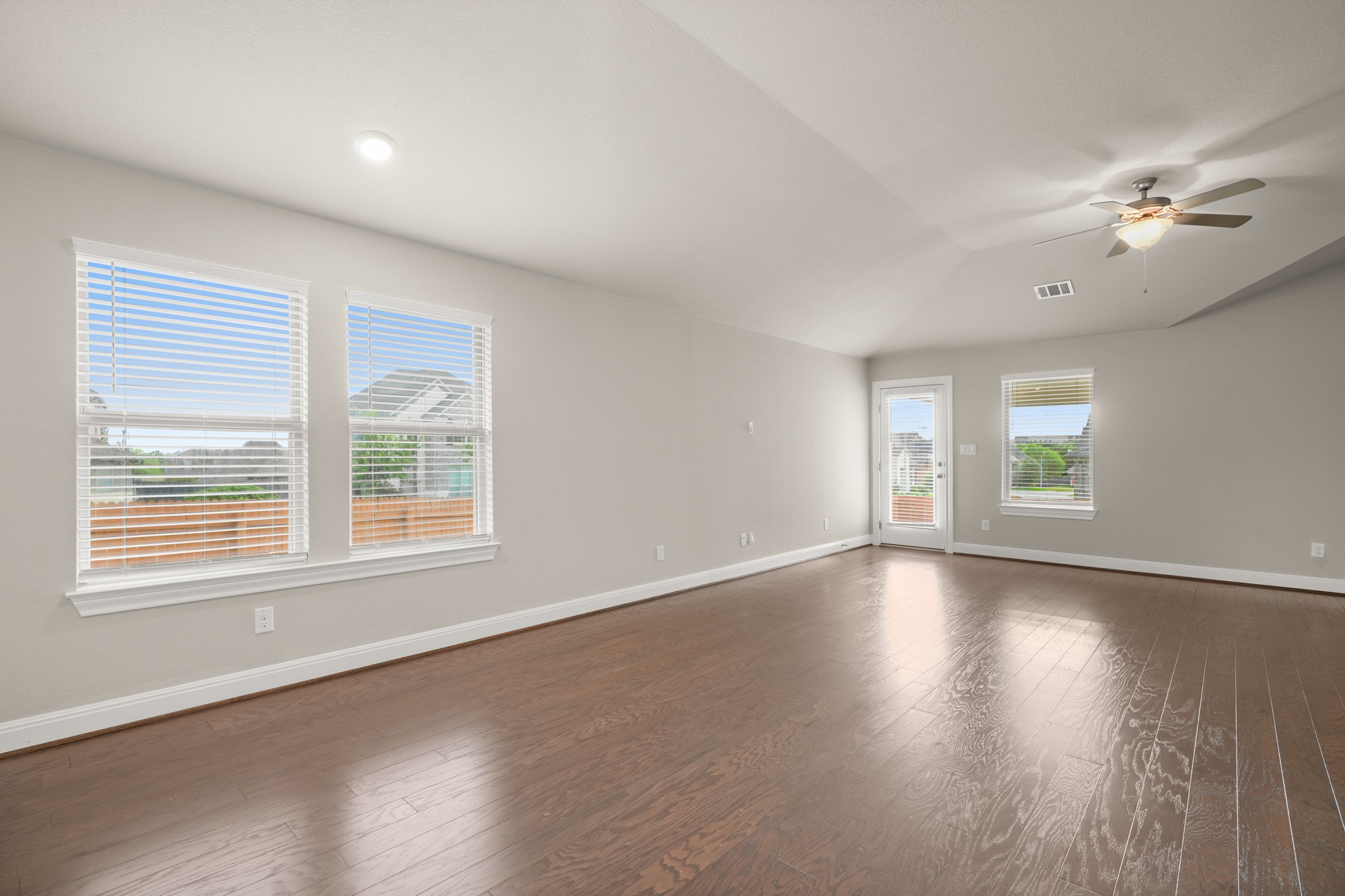 2209 Hat Bender Loop Round Rock, TX 78664 - Photo 10 of 25 a view of an empty room with wooden floor and a window