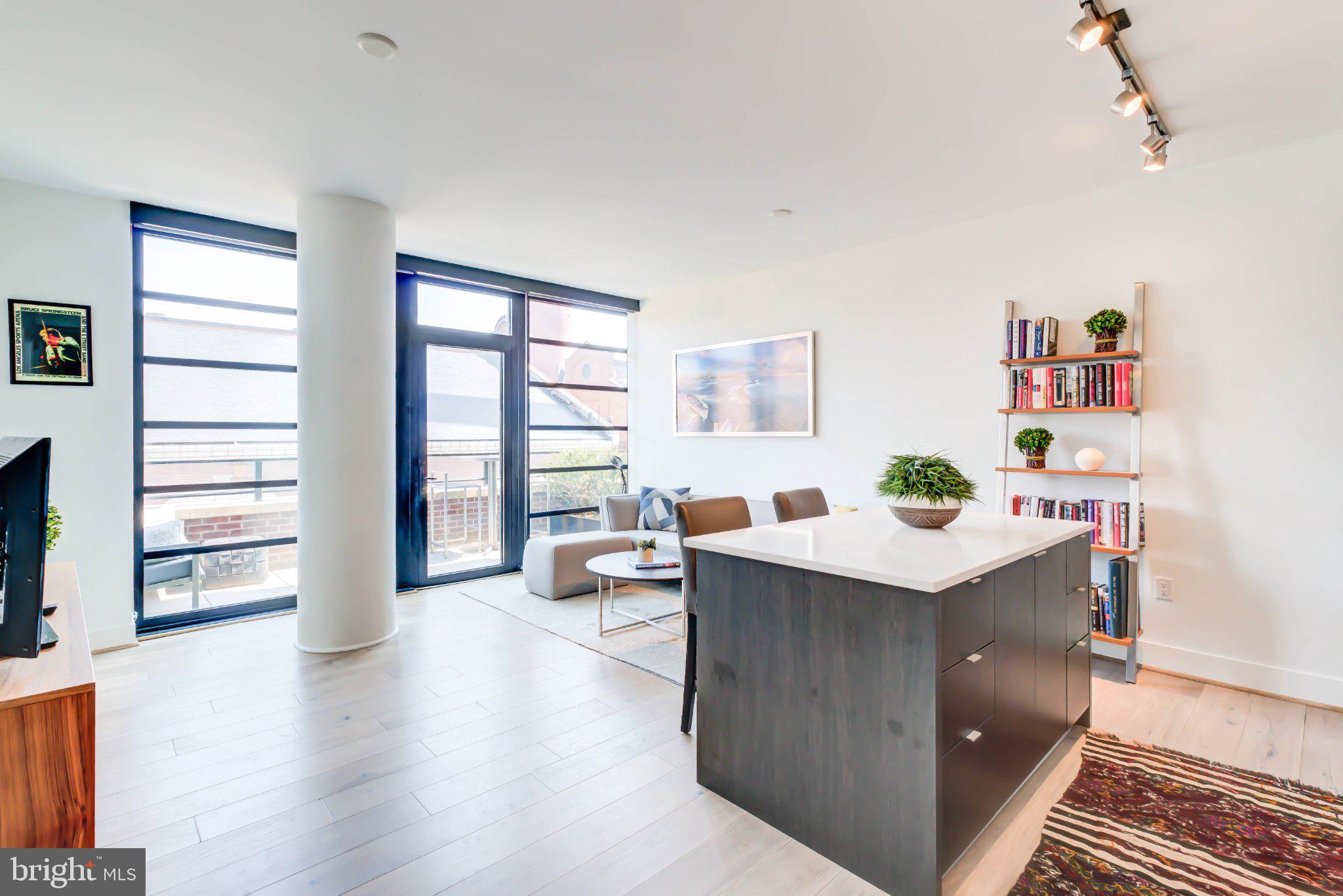 a view of a livingroom with workspace and a window