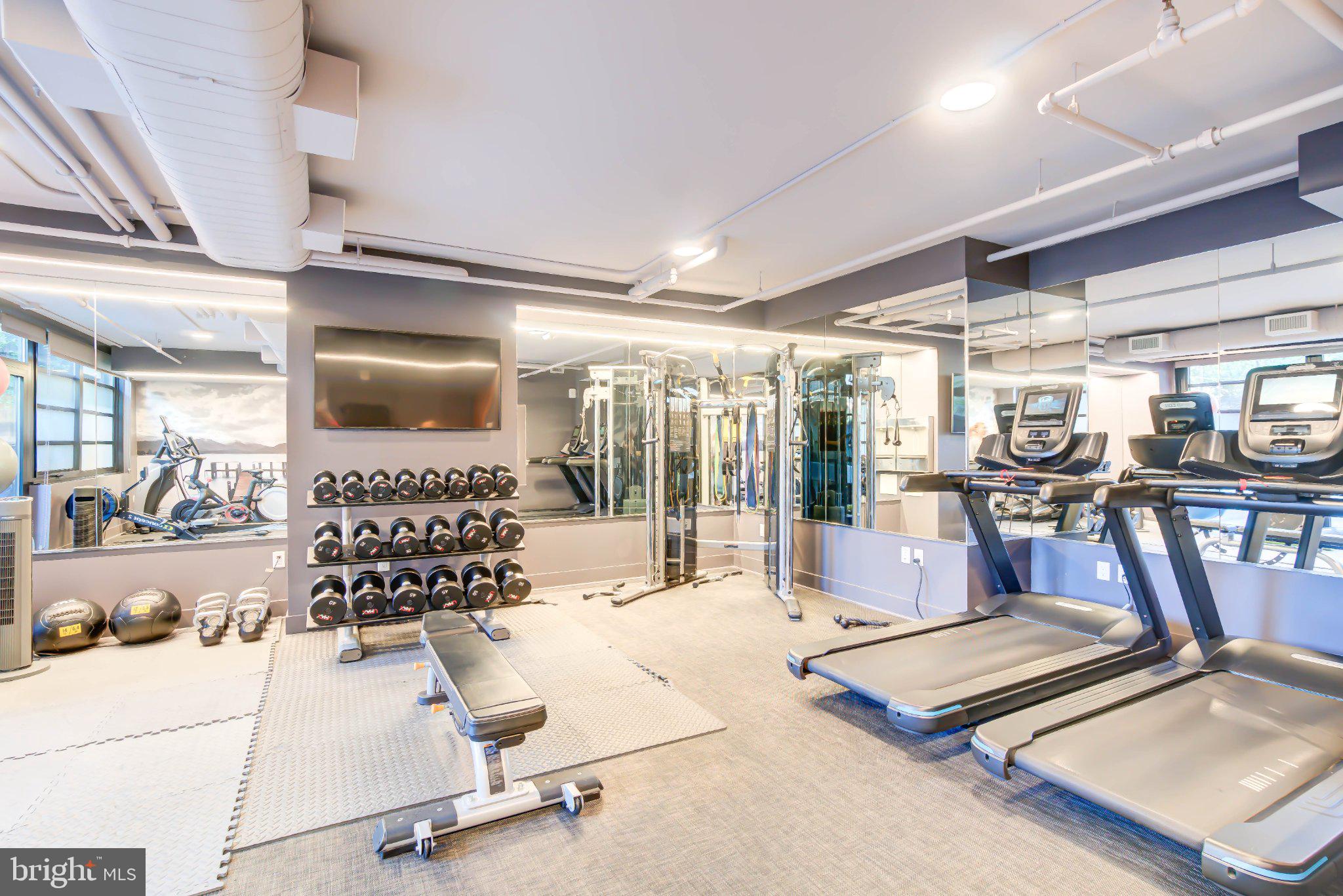1300 4th Street Southeast, Unit 414 Washington, DC 20003 - Photo 12 of 19 a room with gym equipment and a table