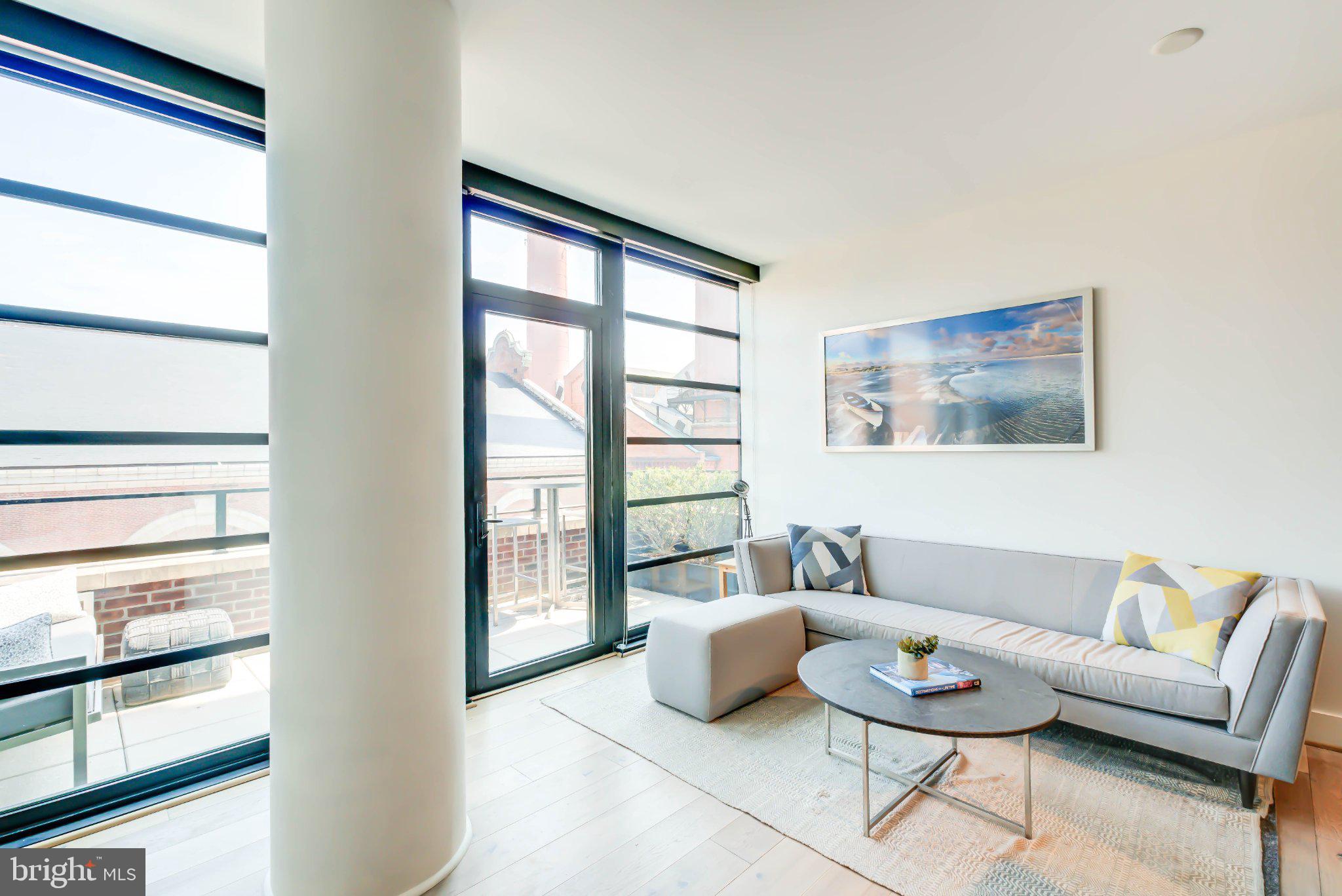 1300 4th Street Southeast, Unit 414 Washington, DC 20003 - Photo 2 of 19 a living room with furniture and a window