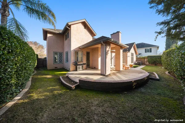 a backyard of a house with table and chairs