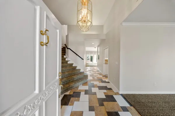 a view of a hallway with windows and stairs