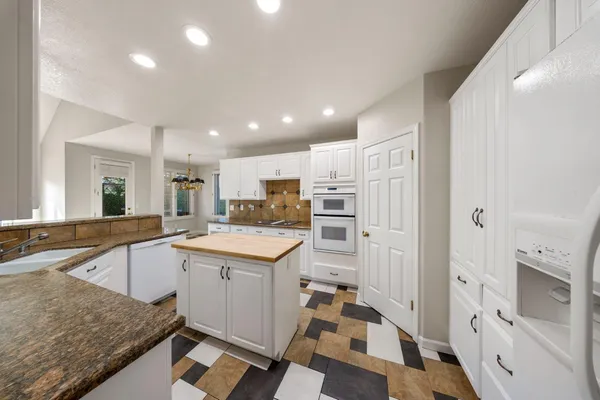 a kitchen with a sink appliances and cabinets