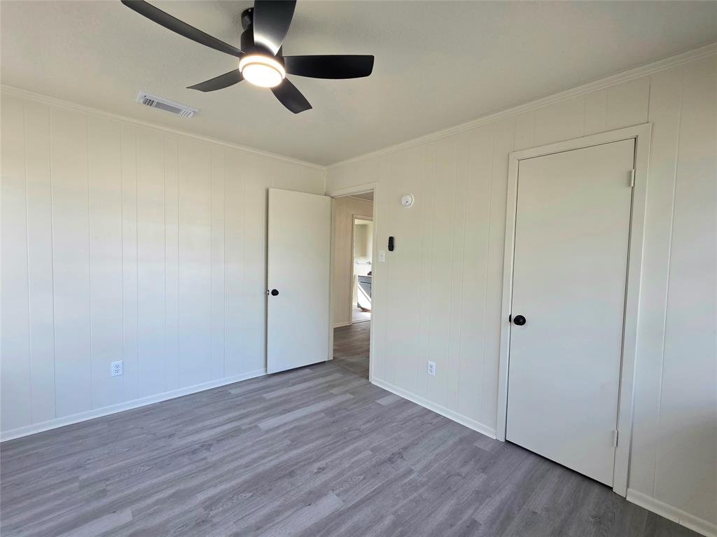 406 East Brazos Street Groesbeck, TX 76642 - Photo 15 of 29 a view of an empty room and wooden floor