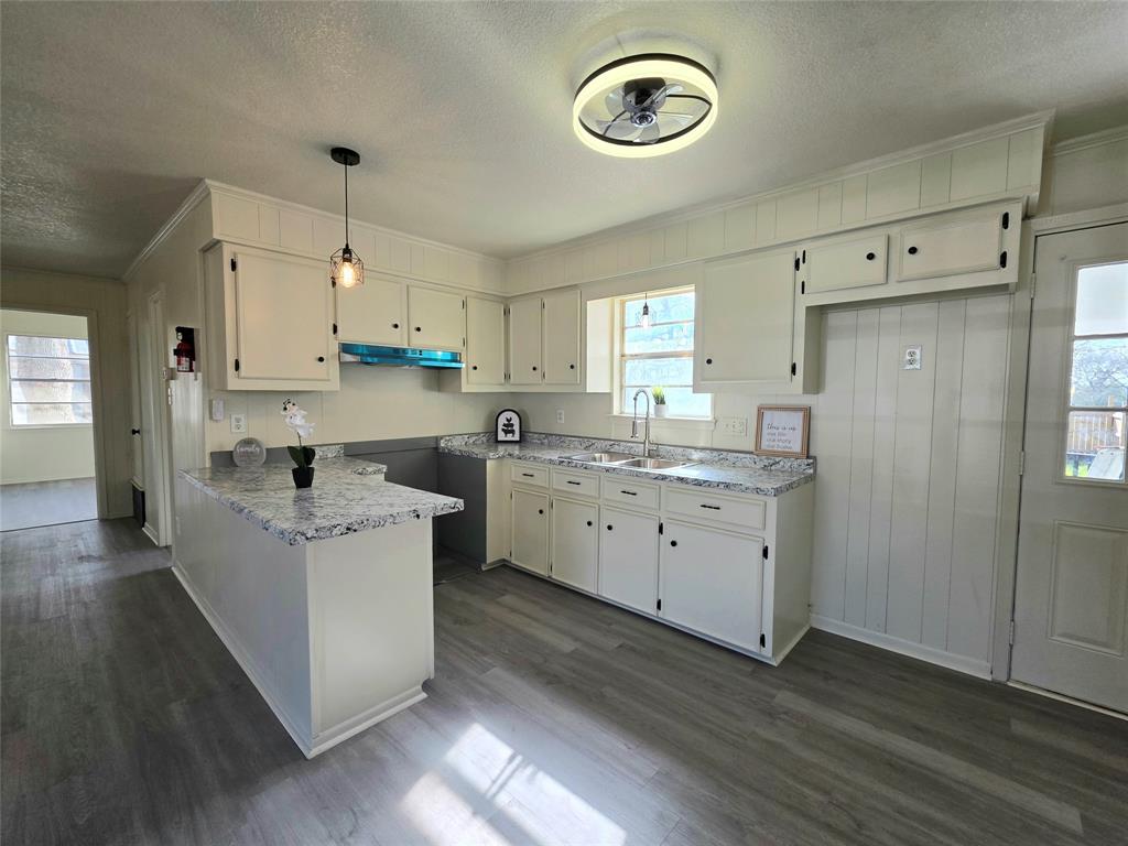 406 East Brazos Street Groesbeck, TX 76642 - Photo 19 of 29 a kitchen with a stove a sink a refrigerator and cabinets