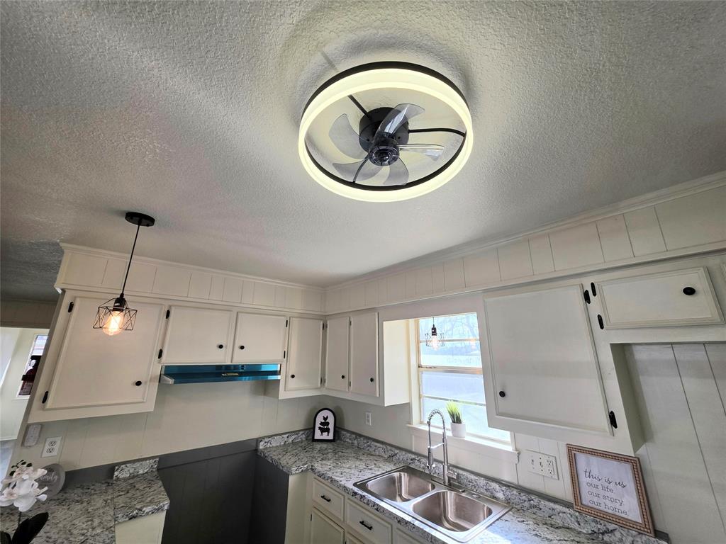 406 East Brazos Street Groesbeck, TX 76642 - Photo 22 of 29 a kitchen with a stove a sink and a stove