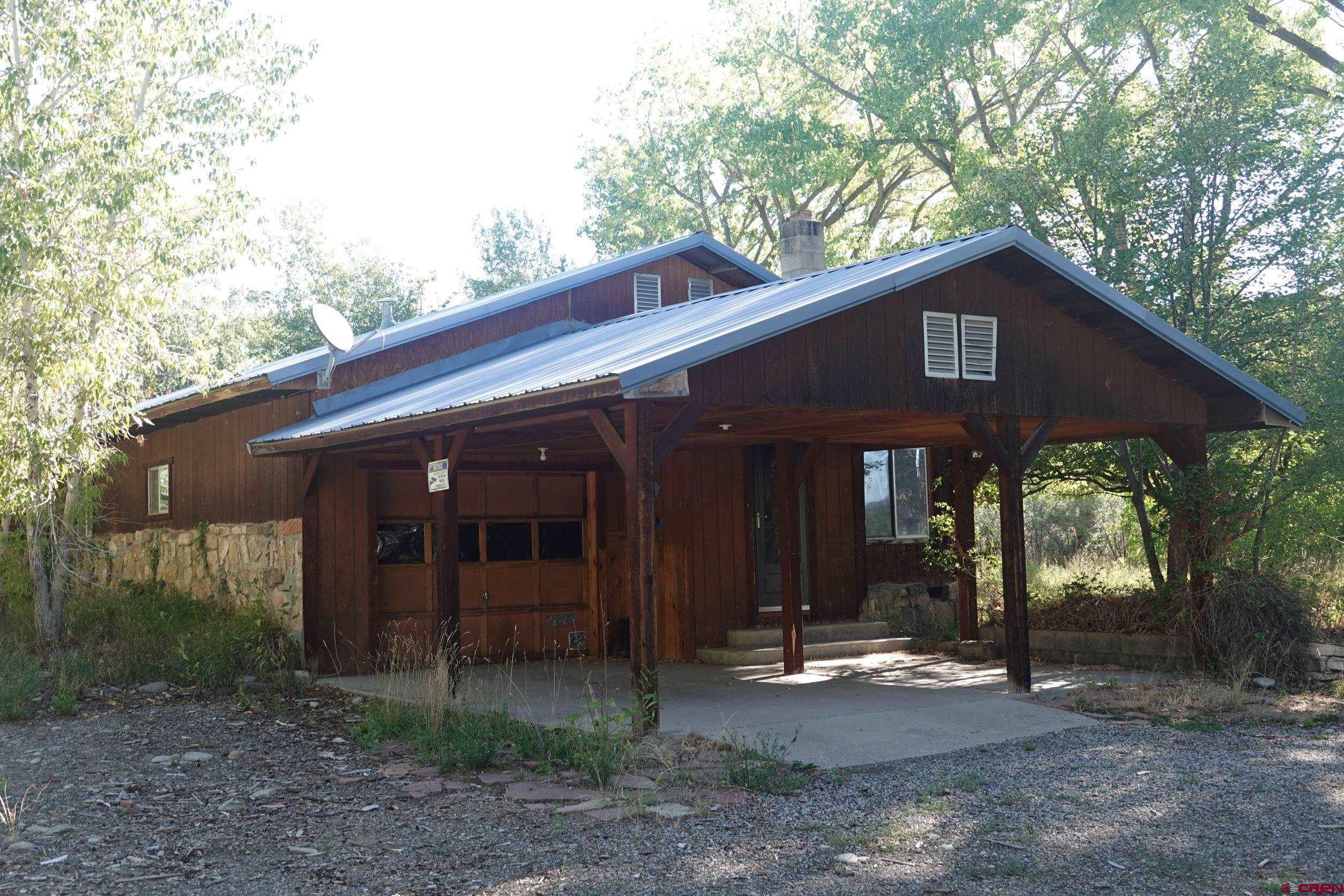 15835 Black Bridge Road Paonia, CO 81428 - Photo 17 of 35 a front view of a house with garden