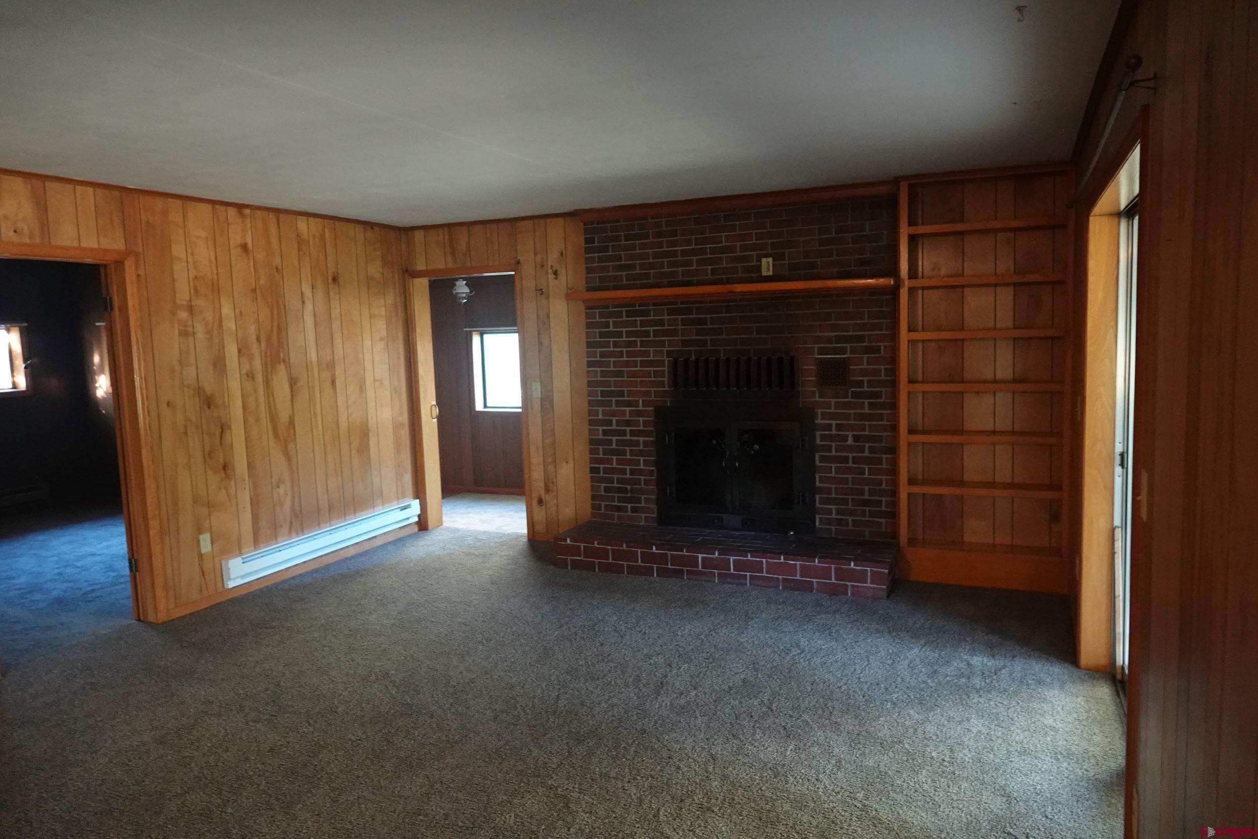 15835 Black Bridge Road Paonia, CO 81428 - Photo 21 of 35 a view of empty room with a fireplace