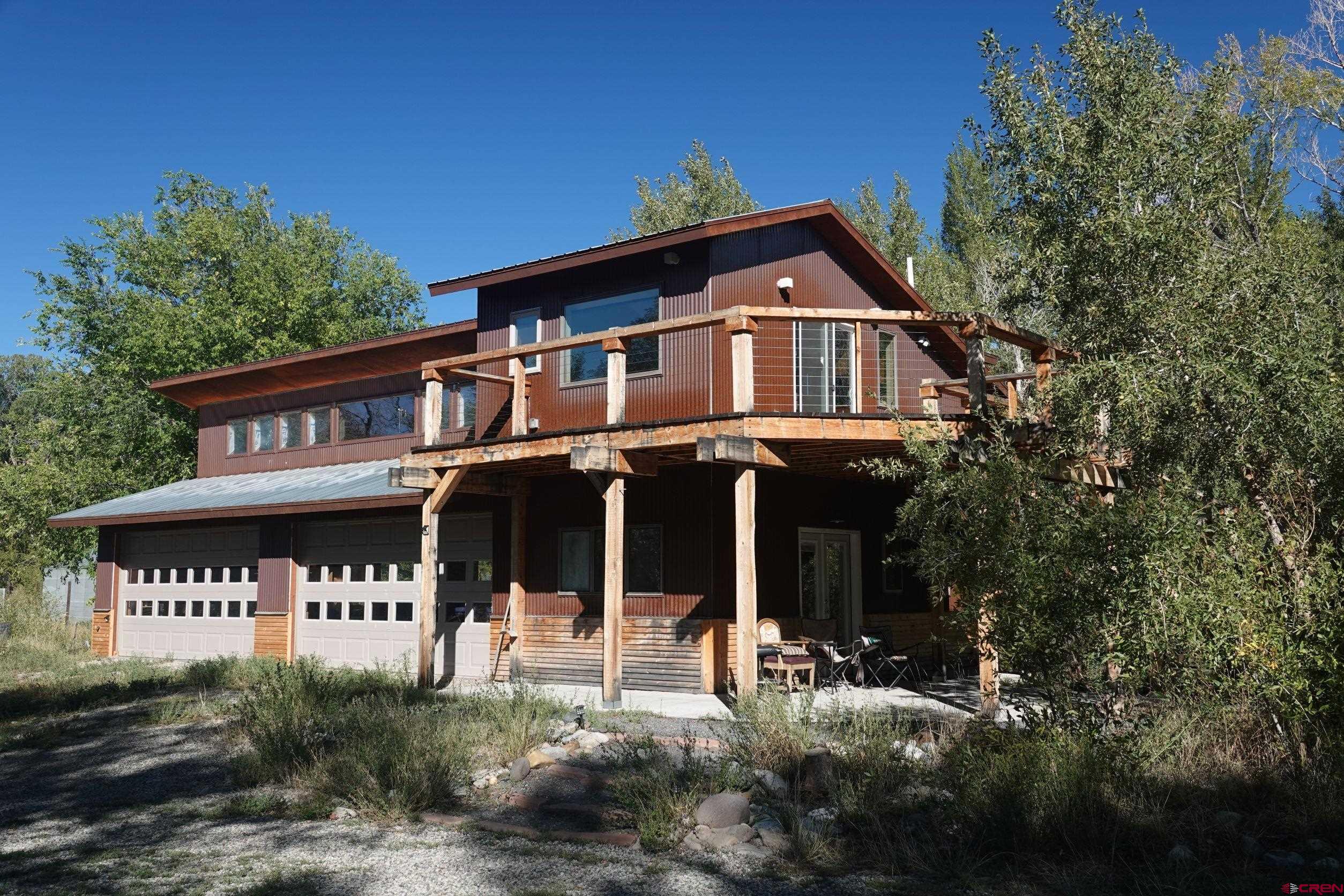 15835 Black Bridge Road Paonia, CO 81428 - Photo 24 of 35 a front view of a house with a garden