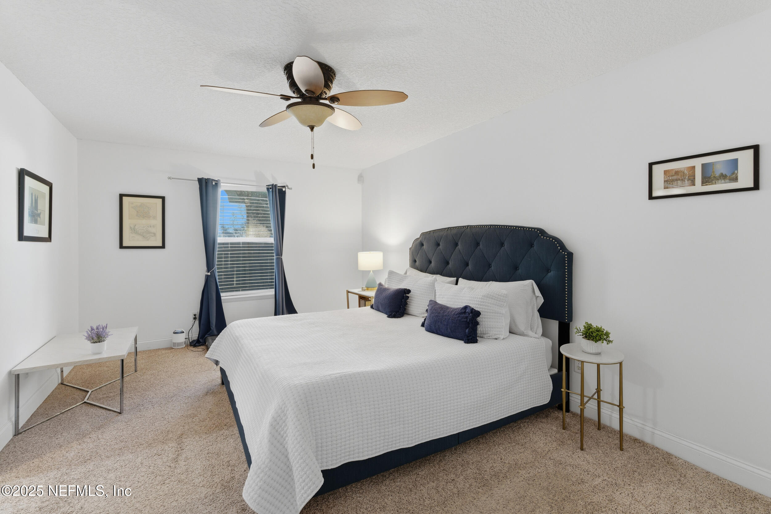 128 Seminole Road, Unit 11 Atlantic Beach, FL 32233 - Photo 10 of 26 a bedroom with a bed a lamp and a potted plant