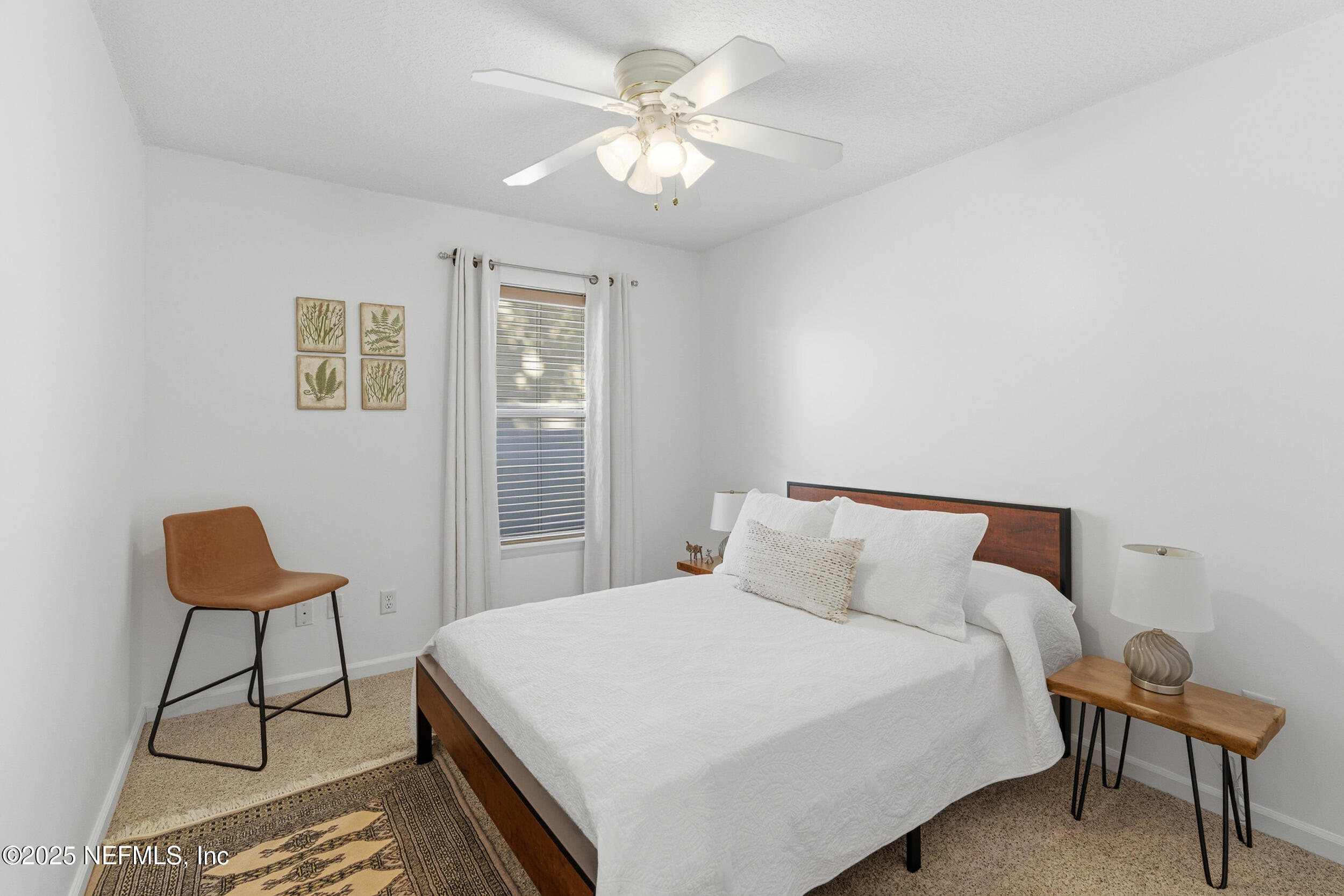 128 Seminole Road, Unit 11 Atlantic Beach, FL 32233 - Photo 15 of 26 a bedroom with a bed and a chandelier