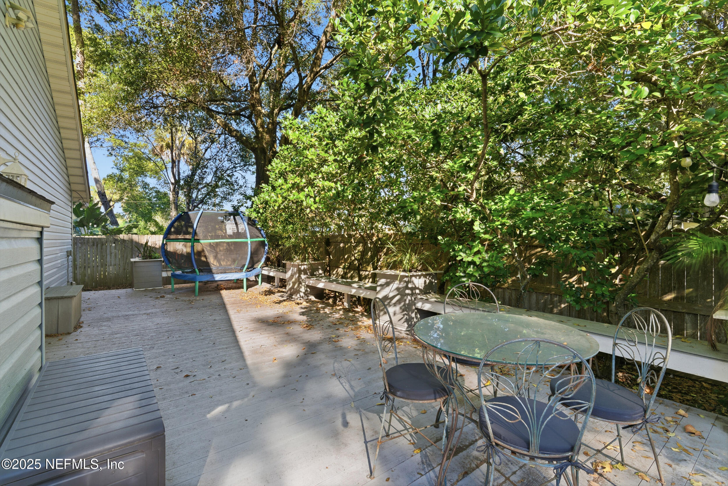 128 Seminole Road, Unit 11 Atlantic Beach, FL 32233 - Photo 18 of 26 a view of a patio with table and chairs and potted plants
