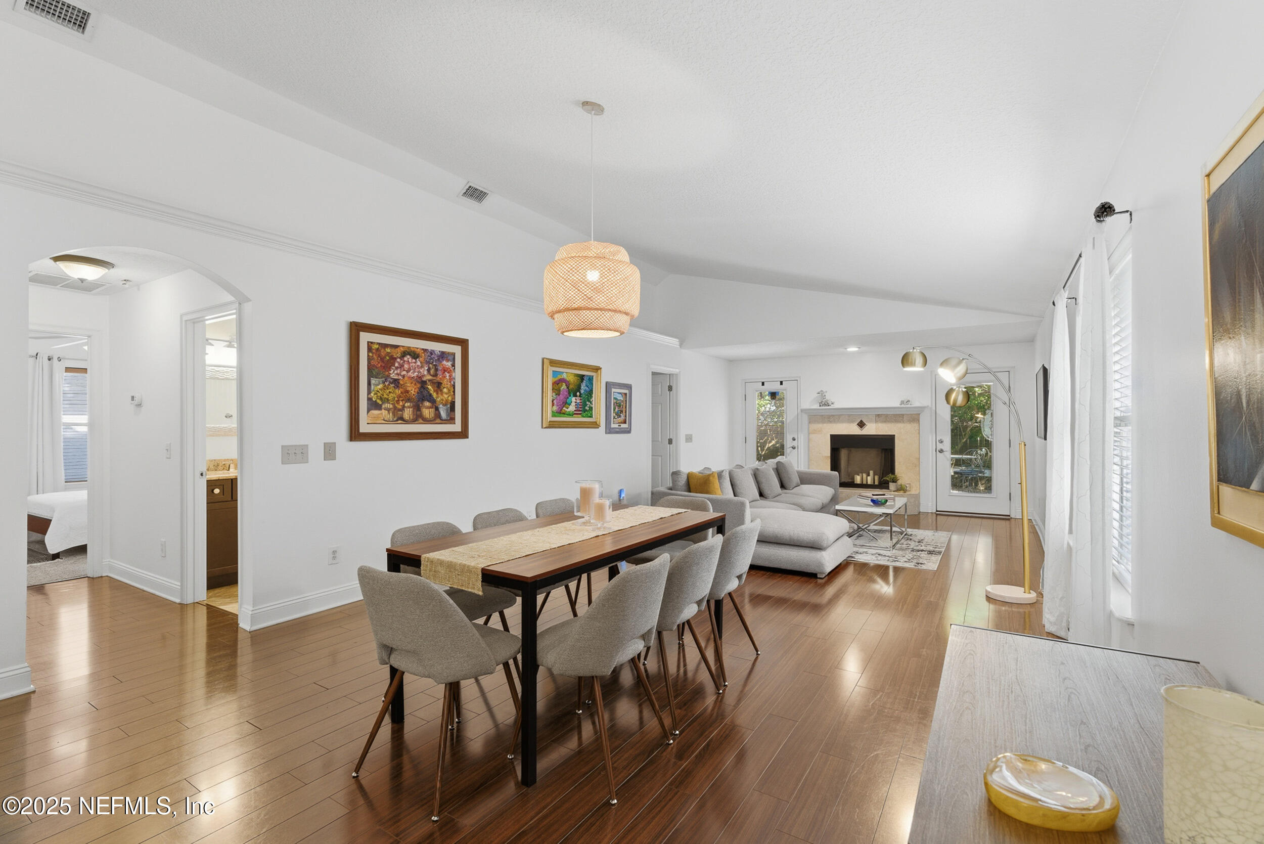 128 Seminole Road, Unit 11 Atlantic Beach, FL 32233 - Photo 3 of 26 a view of a dining room with furniture wooden floor and a chandelier