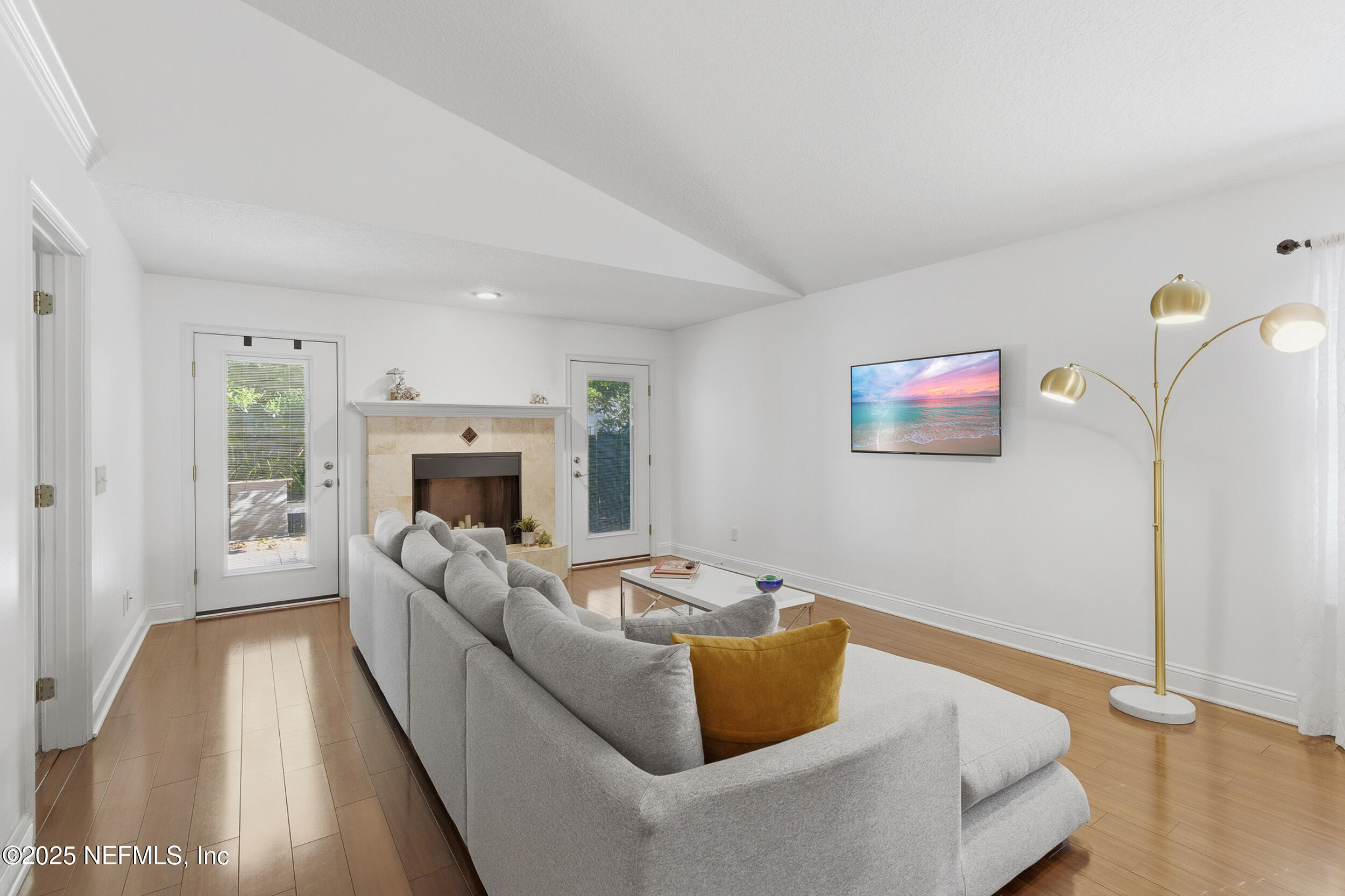 128 Seminole Road, Unit 11 Atlantic Beach, FL 32233 - Photo 9 of 26 a living room with furniture and a fireplace