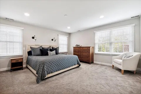 a spacious bedroom with a bed and a couch