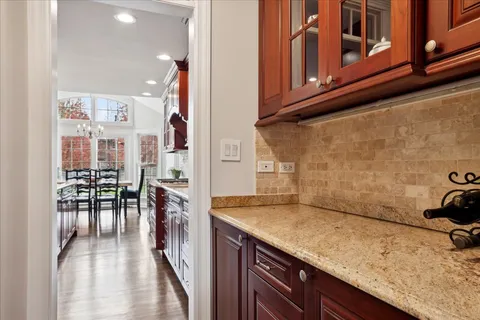 a kitchen with granite countertop a sink a stove and cabinets
