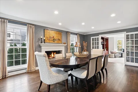 a dining room with furniture window and wooden floor