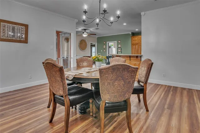 a view of a dining room with furniture and a chandelier