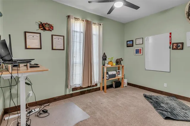 a bedroom with a bed potted plant on the dresser and chandelier