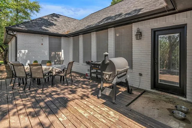a view of a patio with table and chairs and wooden floor