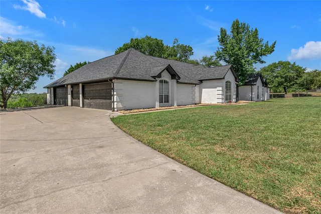 a front view of house with yard and trees