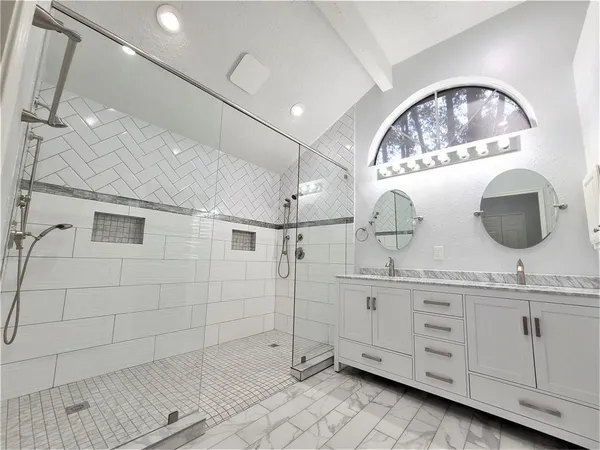 a bathroom with a double vanity sink and mirror